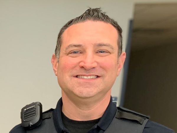 This image depicts Sergeant Matt Harris who heads up Columbus, Ohio's Mobile Crisis Response Unit. He has a smiling and kind expression.
